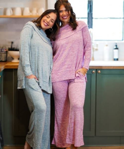 Two women wearing loungewear sets from Heathered Boho Boutique in Palmetto, FL.